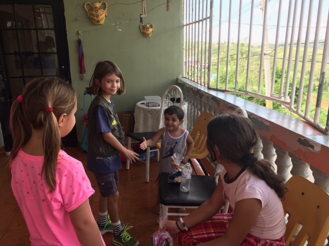 11-25-2017 A charming young friend extends his hand to one of our youngest team members in appreciation for a goodie bag of treats